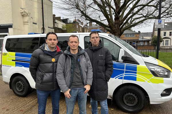 Christophe, Blaise and Rob Blackie in front of a police van